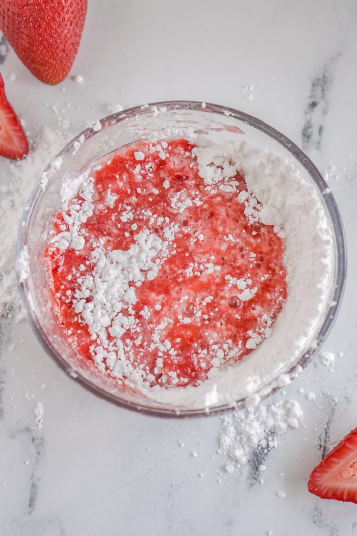 Blended strawberries and powdered sugar in a bowl
