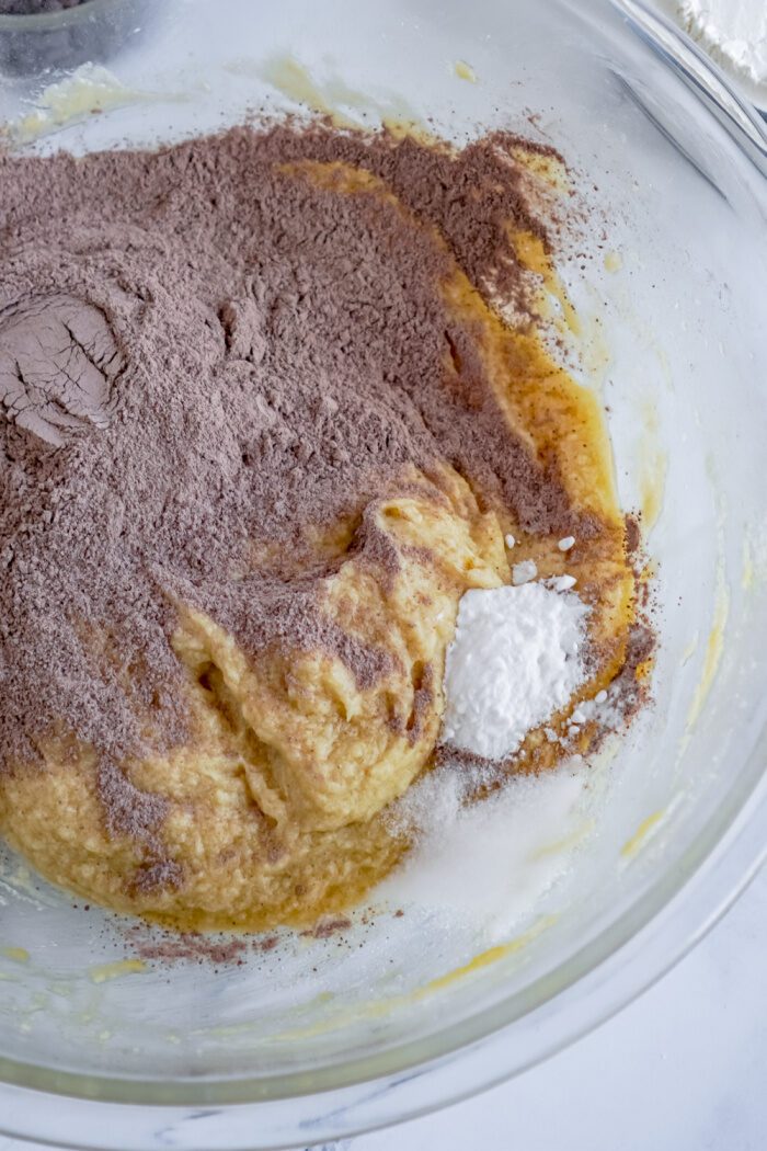 Chocolate pudding and baking soda added to bowl