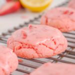 Close up of glazed Strawberry Cake Mix Cookie on cooling rack