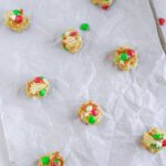 Cookie dough balls with toppings on baking rack