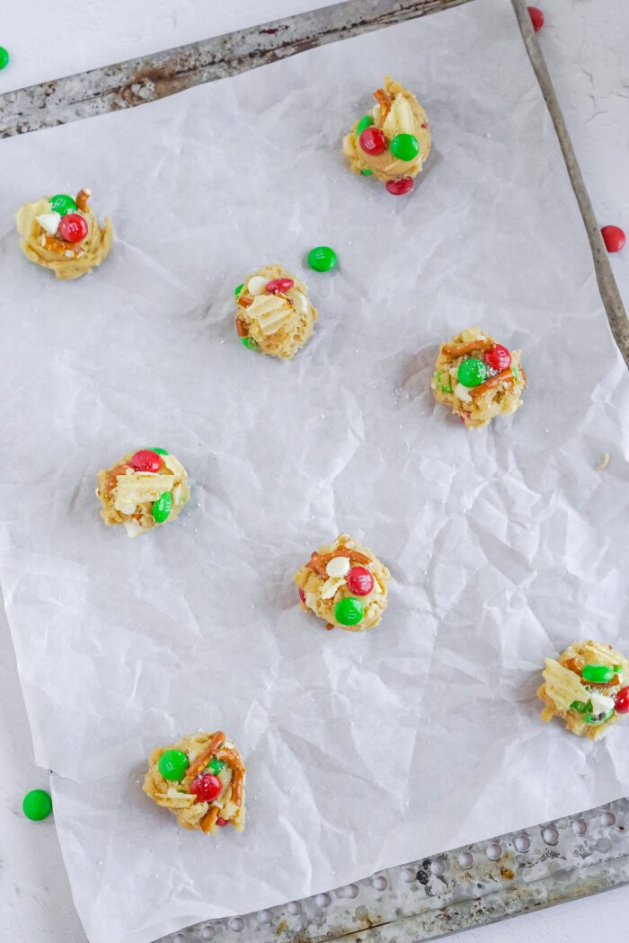 Cookie dough balls with toppings on baking rack