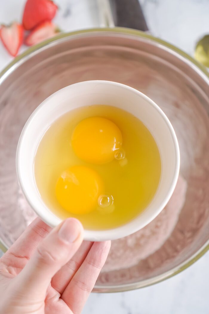 Eggs being added to the bowl