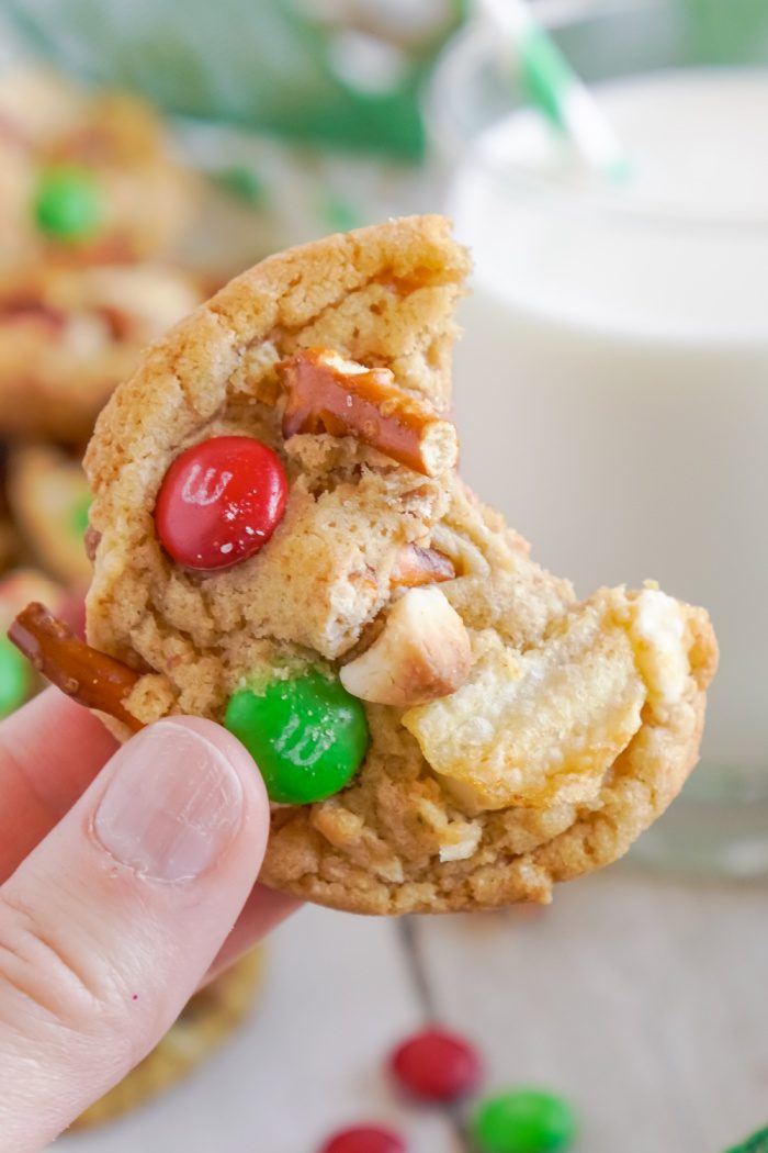 Close up of someone holding a Kitchen Sink Christmas Cookie with a bite taken out of it