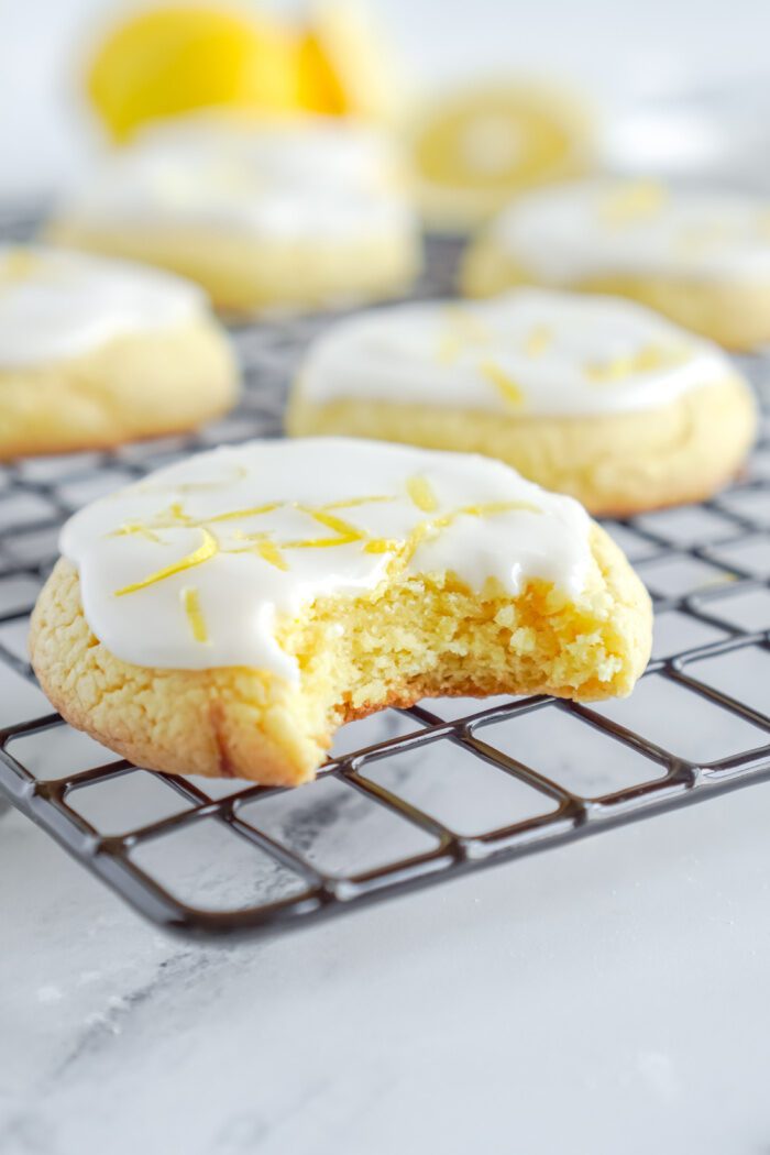 Iced Lemon cookie with a bite taken out of it