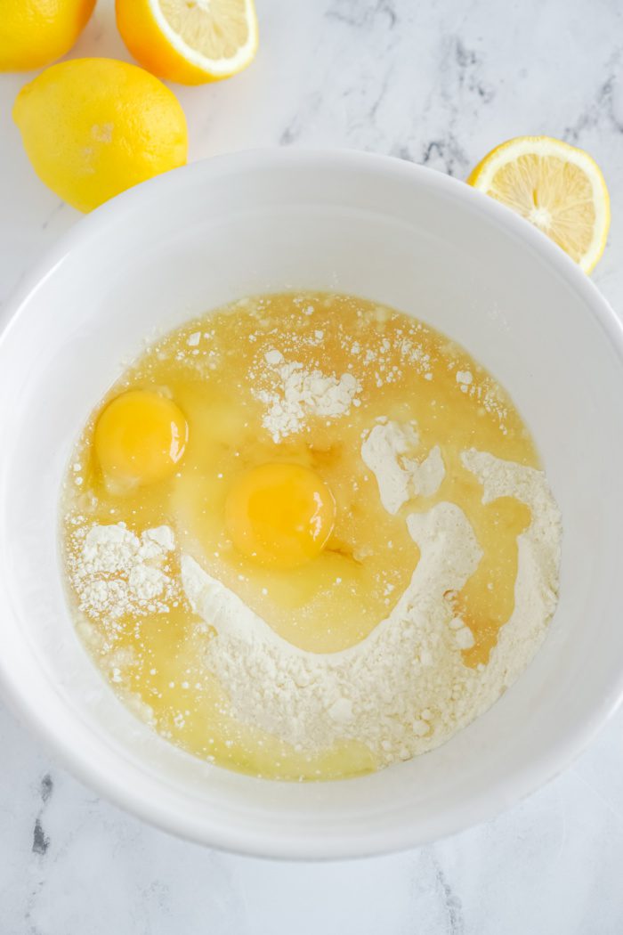 Lemon cake mix, eggs, vanilla, and oil in a bowl