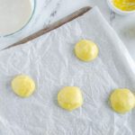 Lemon cookie dough balls on baking sheet