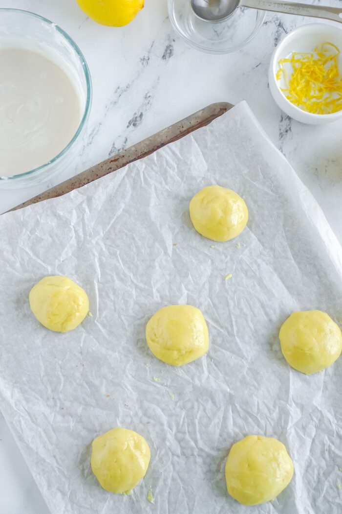 Lemon cookie dough balls on baking sheet