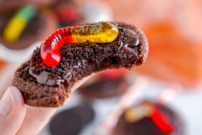 Close up of someone holding an Oreo Dirt Pudding Cookie with a bite taken out of it