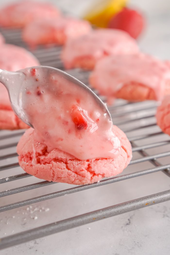 Pouring Strawberry glaze on a strawberry cookie