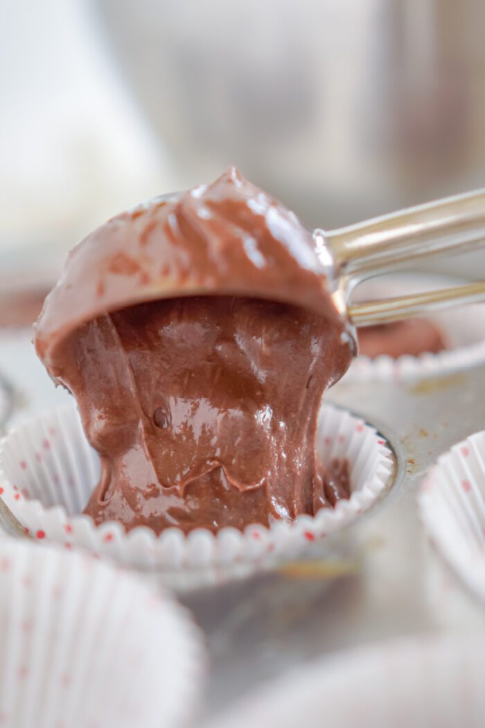 Pouring the Hot Chocolate Cupcake batter into a cupcake liner