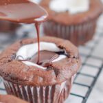 Pouring the frosting on top of the Hot Chocolate Cupcake