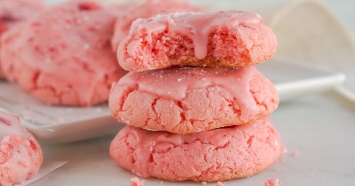 Stack of 3 Strawberry Cookies with a bite taken out of the top cookie