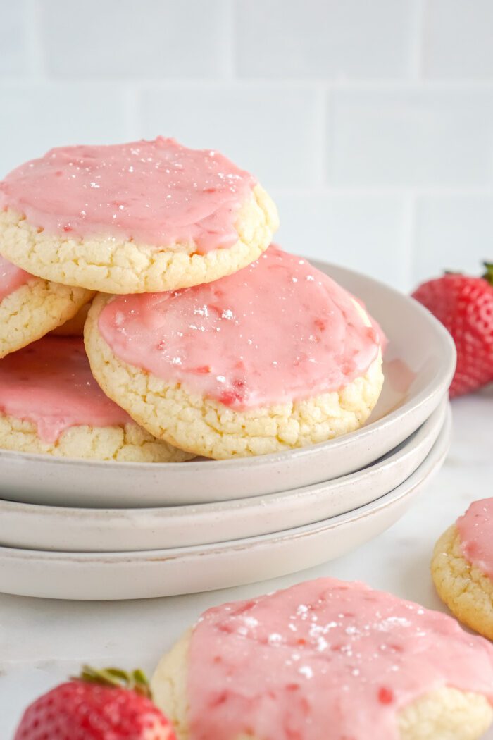 A stack of strawberry sugar cookies on a plate.