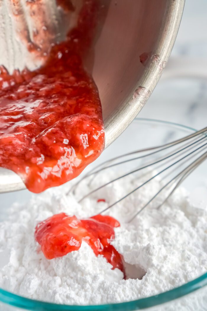 Adding strawberry puree to powdered sugar.