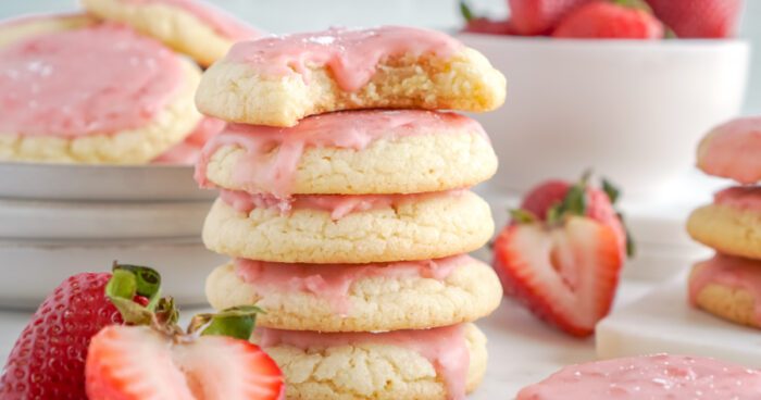 A stack of four strawberry sugar cookies.
