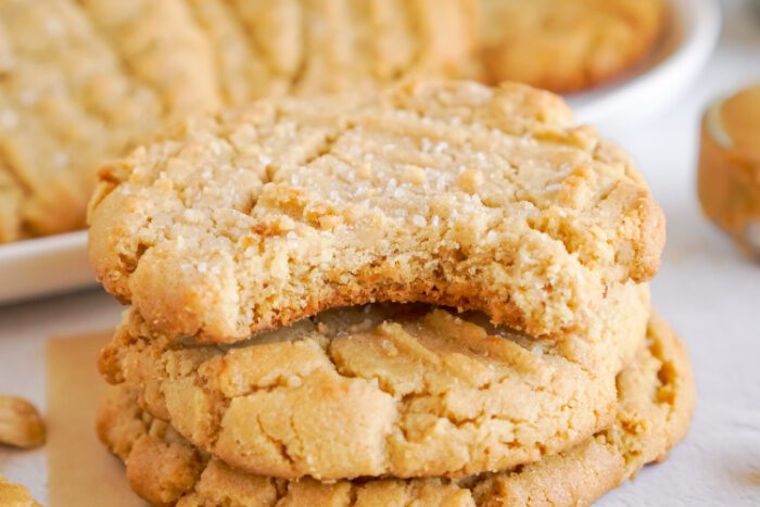 Wide view of a stack of Peanut Butter Cookies with a bite taken out of the top cookie