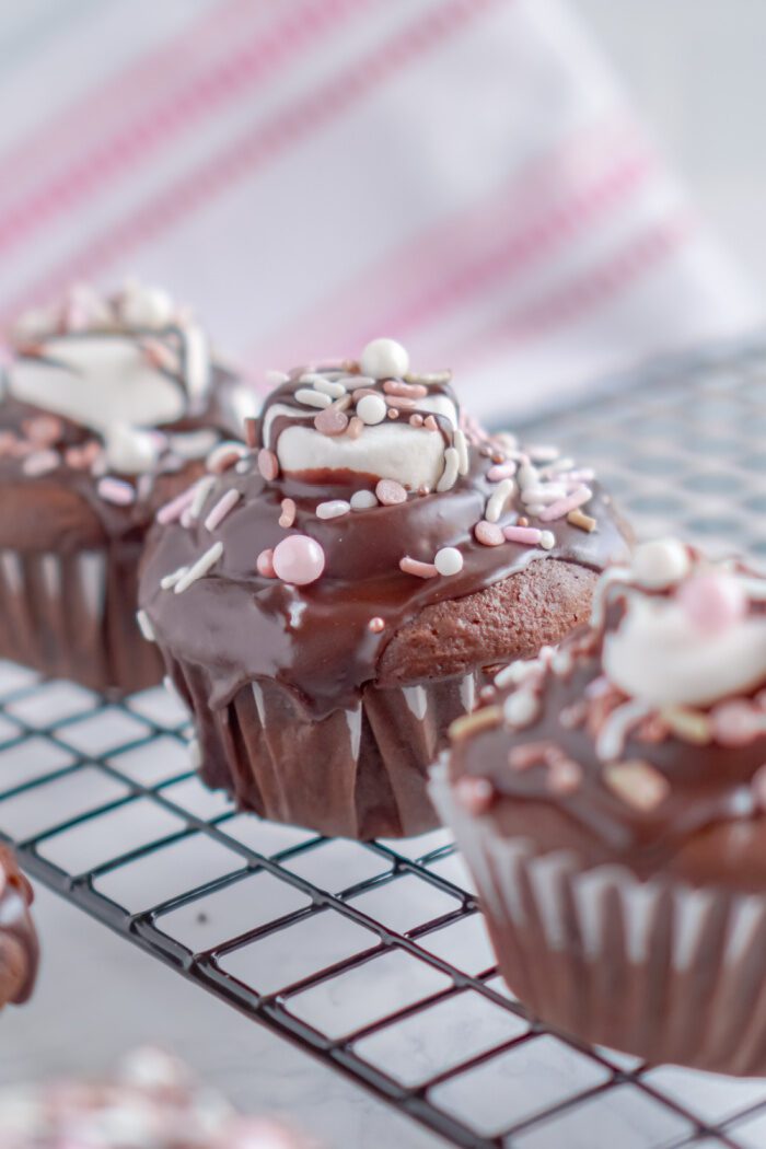 Valentine's Day Hot Chocolate Cupcakes lined up on a cooling rack