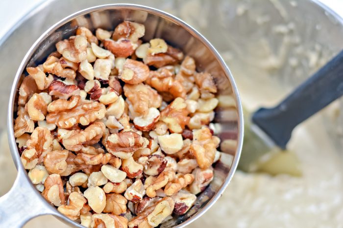 Adding chopped nuts into bowl
