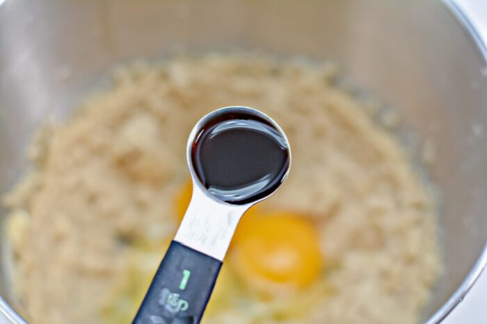 Adding teaspoon of vanilla into bowl