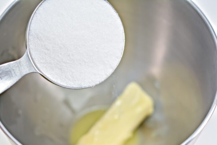 Pouring white sugar into bowl