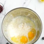 Blueberry muffin mix, milk, eggs, and lemon juice in a bowl