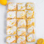 Cut Lemon sugar cookie bars with lemon glaze