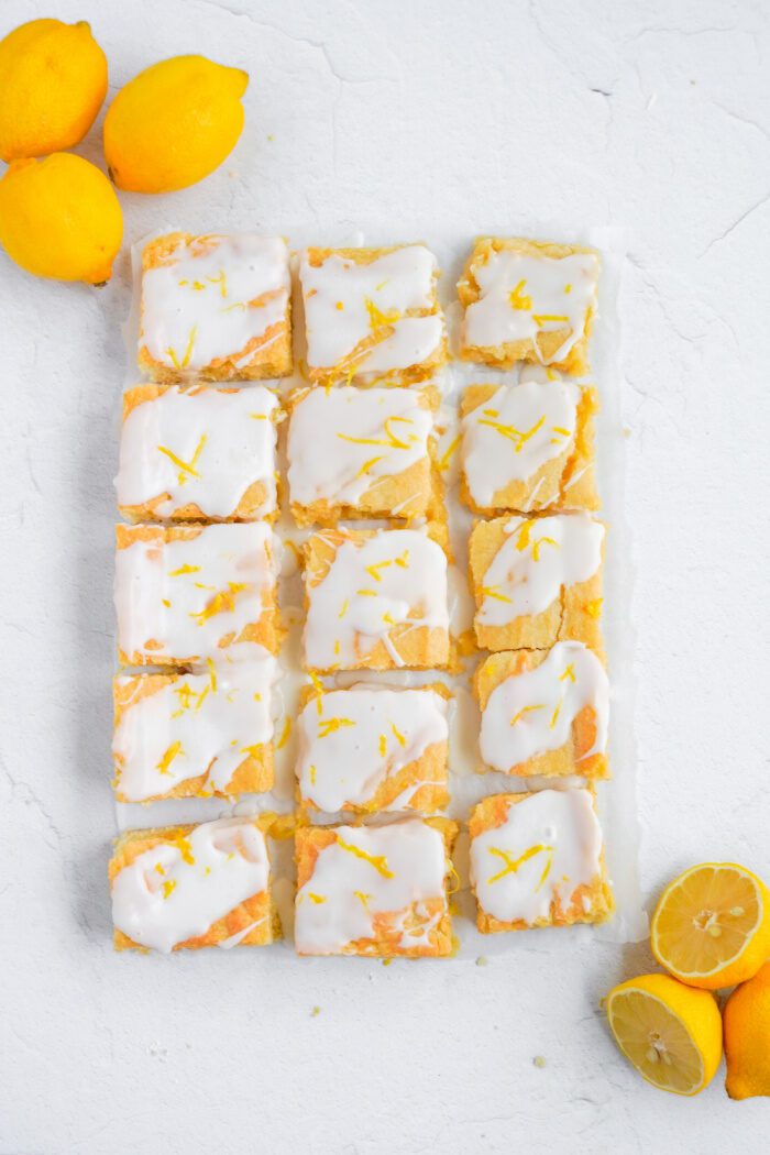 Cut Lemon sugar cookie bars with lemon glaze