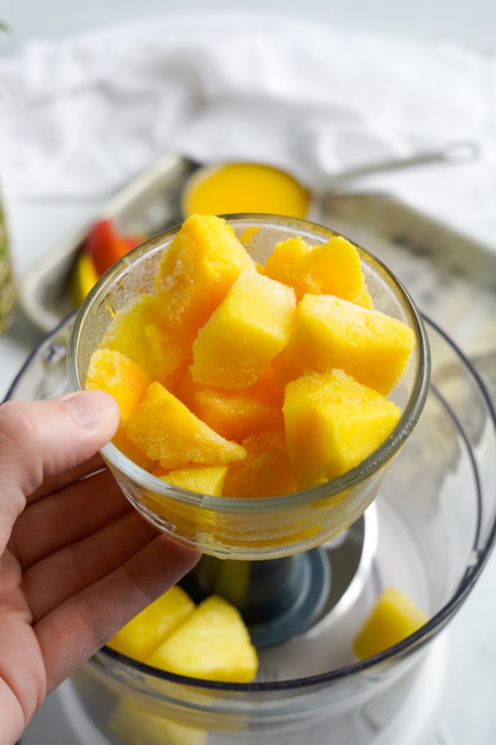Pouring the mango into the blender