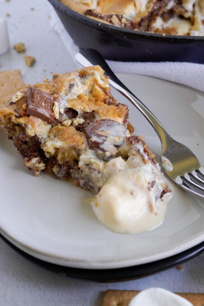 Slice of S'mores Skillet Cookie with ice cream