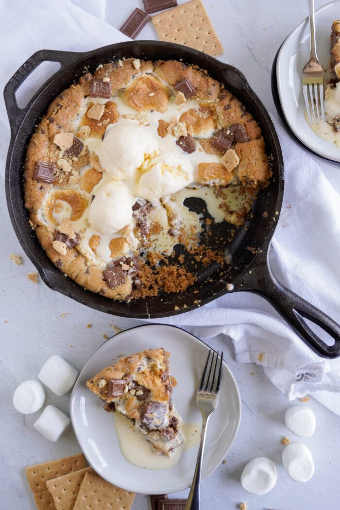 S'mores Skillet Cookie with a slice of it on a plate