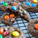Chocolate M&M cookies on cooling rack