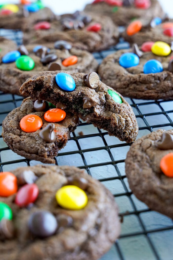 Chocolate M&M cookies on cooling rack