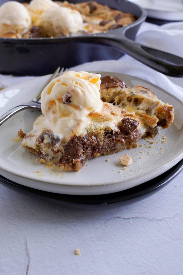 Close up of slice of Skillet Chocolate Chip Cookie with ice cream