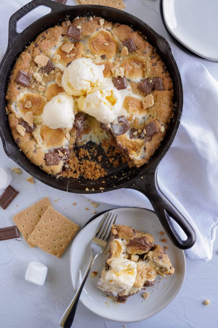 S'mores Chocolate Chip Skillet Cookie with slice on a plate next to it