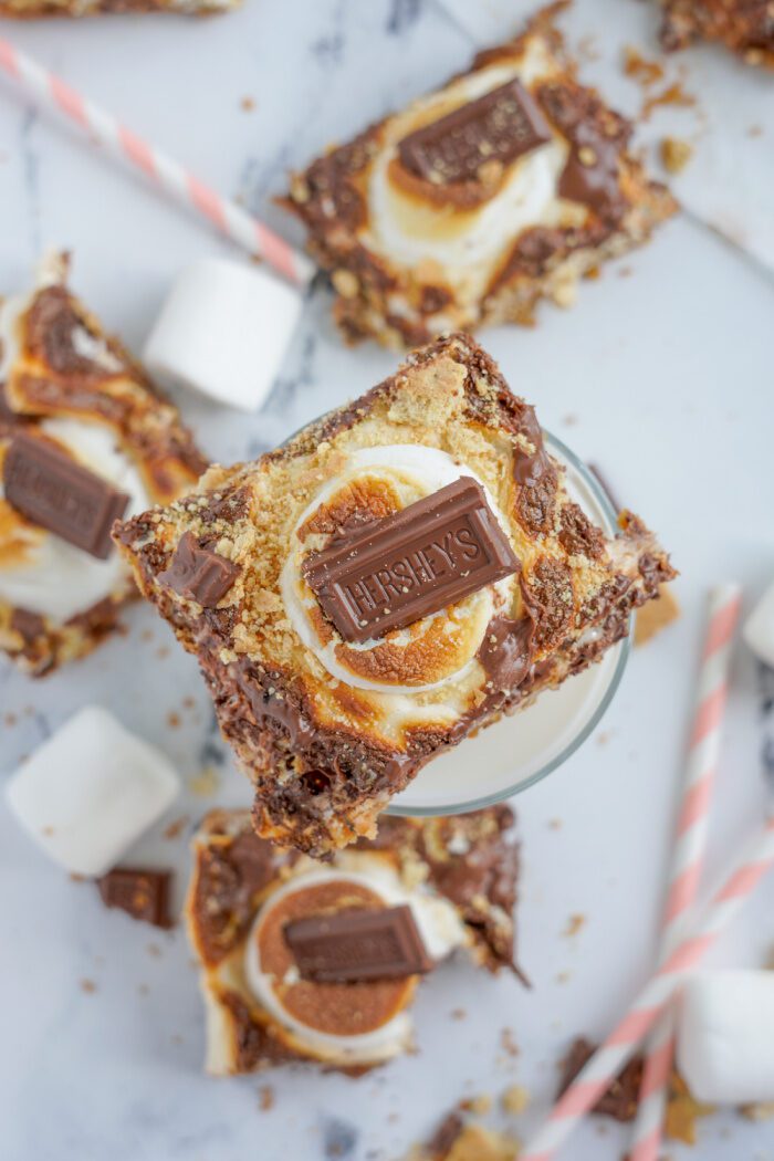 Above view of a s'mores bar on top of a glass of milk