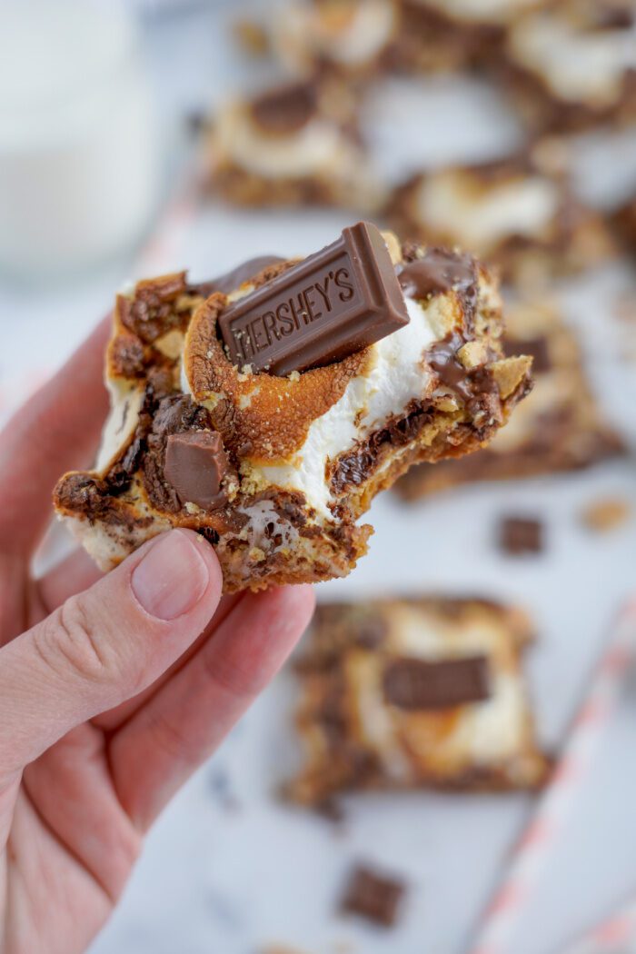 A hand holding a s'mores bar.