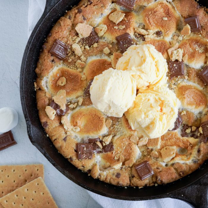 Close up S'mores Chocolate Chip Skillet Cookie with ice cream on top