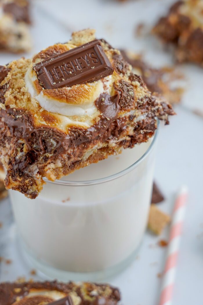 S'mores Magic Bars on top of a glass of milk