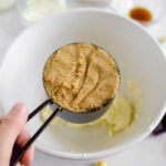 Brown sugar being added to butter