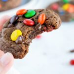 Easy Double Chocolate M&M Cookies Broken Bite in Hand