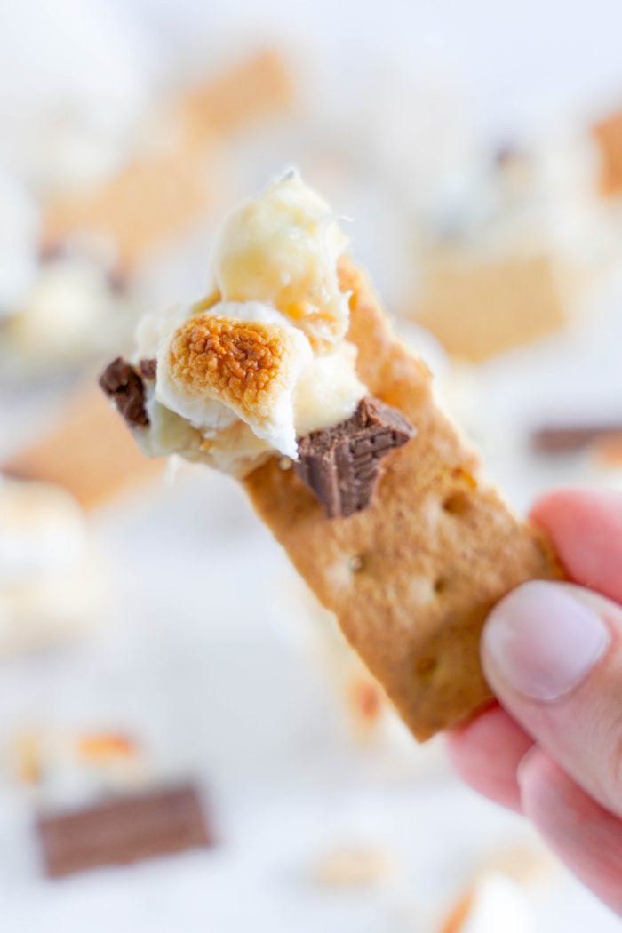 A bite of S'mores Cookie Dip on a graham cracker
