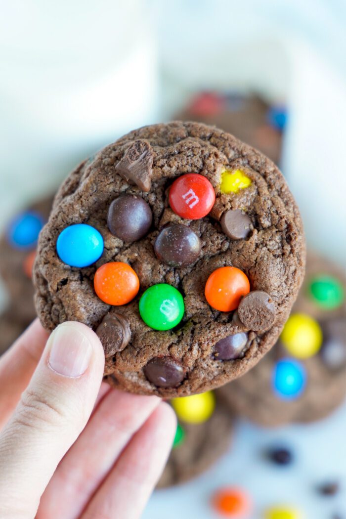 Someone holding an M&M cookie