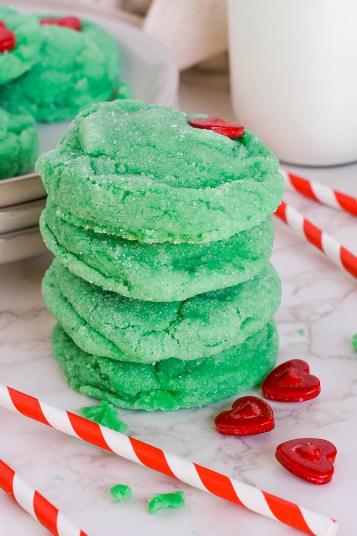 A stack of four green sugar cookies.