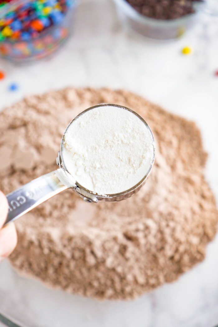 Flour being added to the mixing bowl