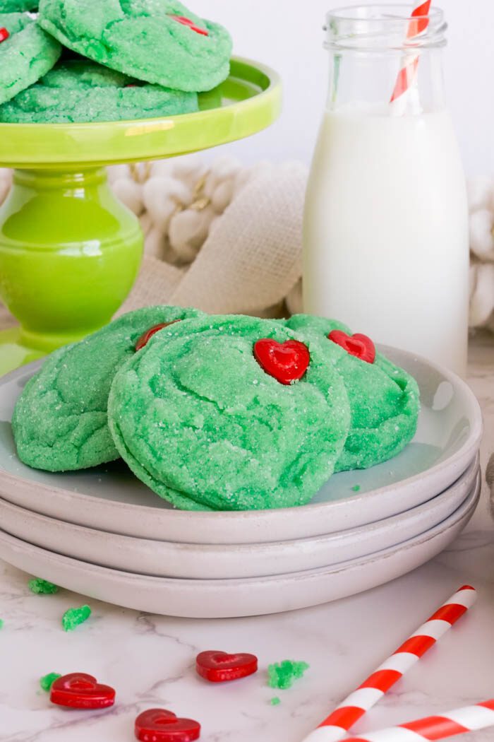 Green cookies with red heart-shaped sprinkles.