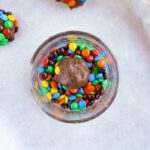 M&M cookie dough ball in a bowl of M&Ms