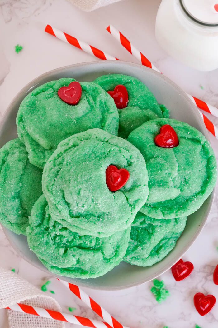 Green sugar cookies with red heart candies.