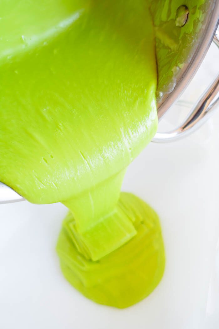 Green slime being poured from a metal bowl.