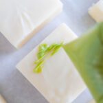 Drizzling green almond bark onto fudge squares