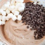 Marshmallows and chocolate chips added to bowl
